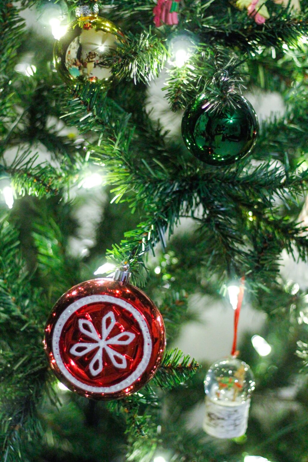Christmas tree decorated with colourful ornaments and warm fairy lights