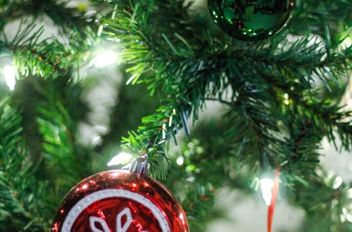 Christmas tree decorated with colourful ornaments and warm fairy lights